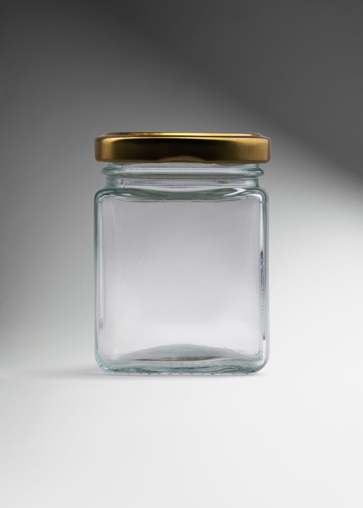 Frasco cuadrado de vidrio transparente con tapa de rosca dorada premium para miel, especias y recuerdos 150 ml — imagen de producto