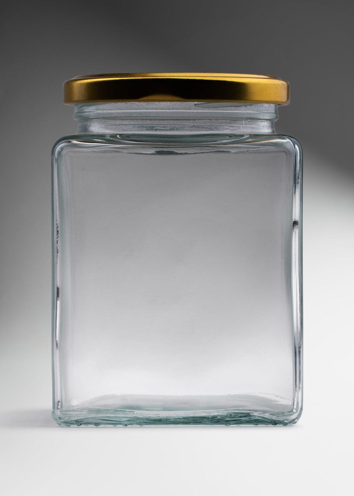 Frasco cuadrado de vidrio transparente con tapa de rosca dorada premium para almacenamiento y decoración 500 ml — imagen de producto