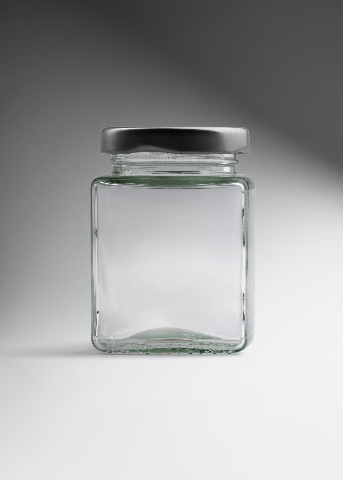 Frasco cuadrado de vidrio transparente con tapa de rosca plata premium para miel, especias y recuerdos 100 ml — imagen de producto