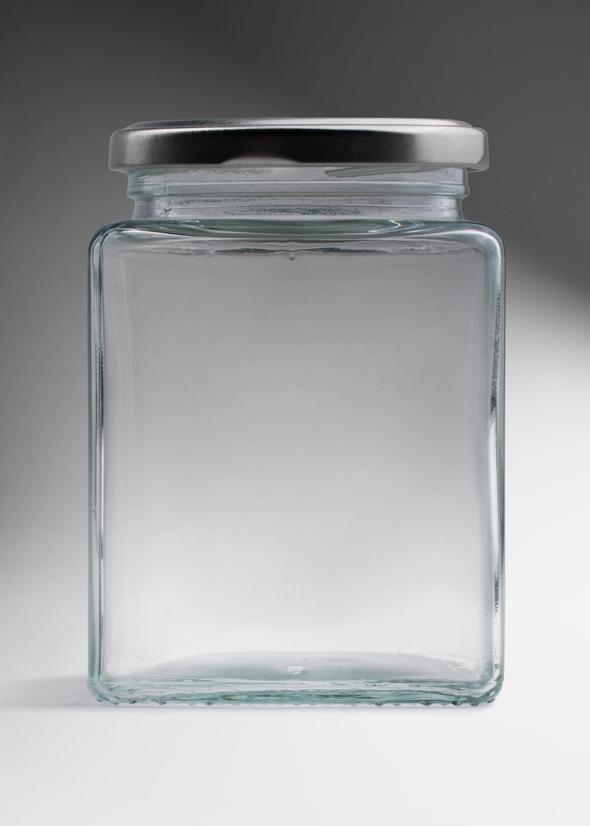Frasco cuadrado de vidrio transparente con tapa de rosca plata premium para almacenamiento y decoración 500 ml — imagen de producto