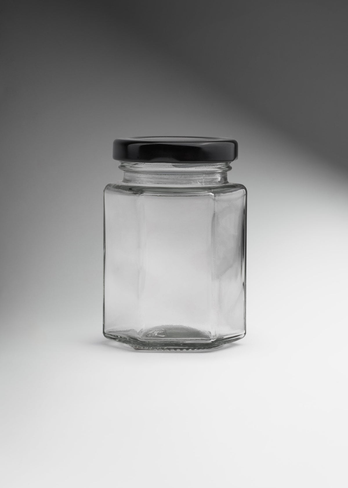 Frascos hexagonales de vidrio transparente con tapa negra uso alimenticio de 45 a 500 ml — imagen de producto