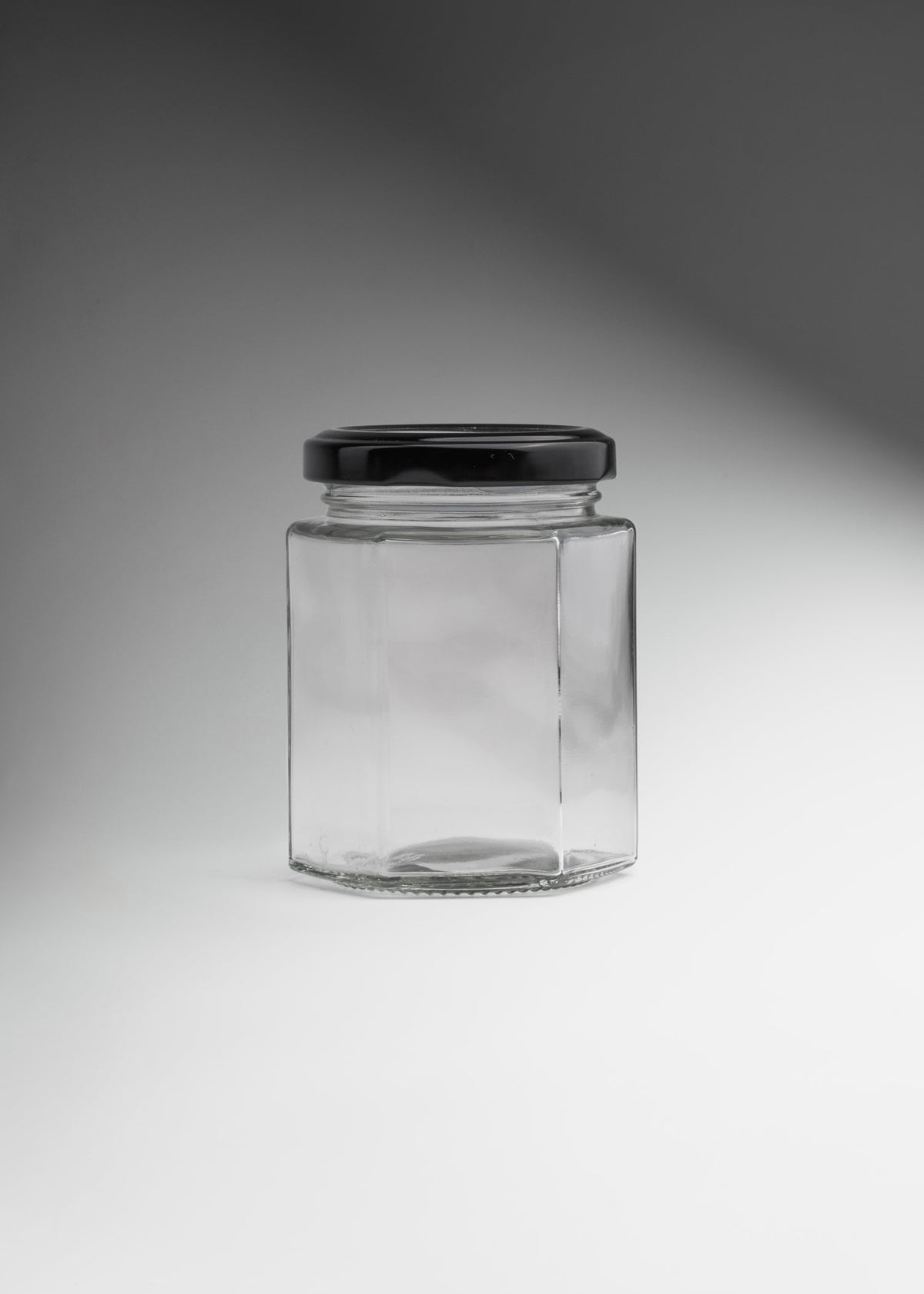 Frascos hexagonales de vidrio transparente con tapa negra uso alimenticio de 45 a 500 ml — imagen de producto