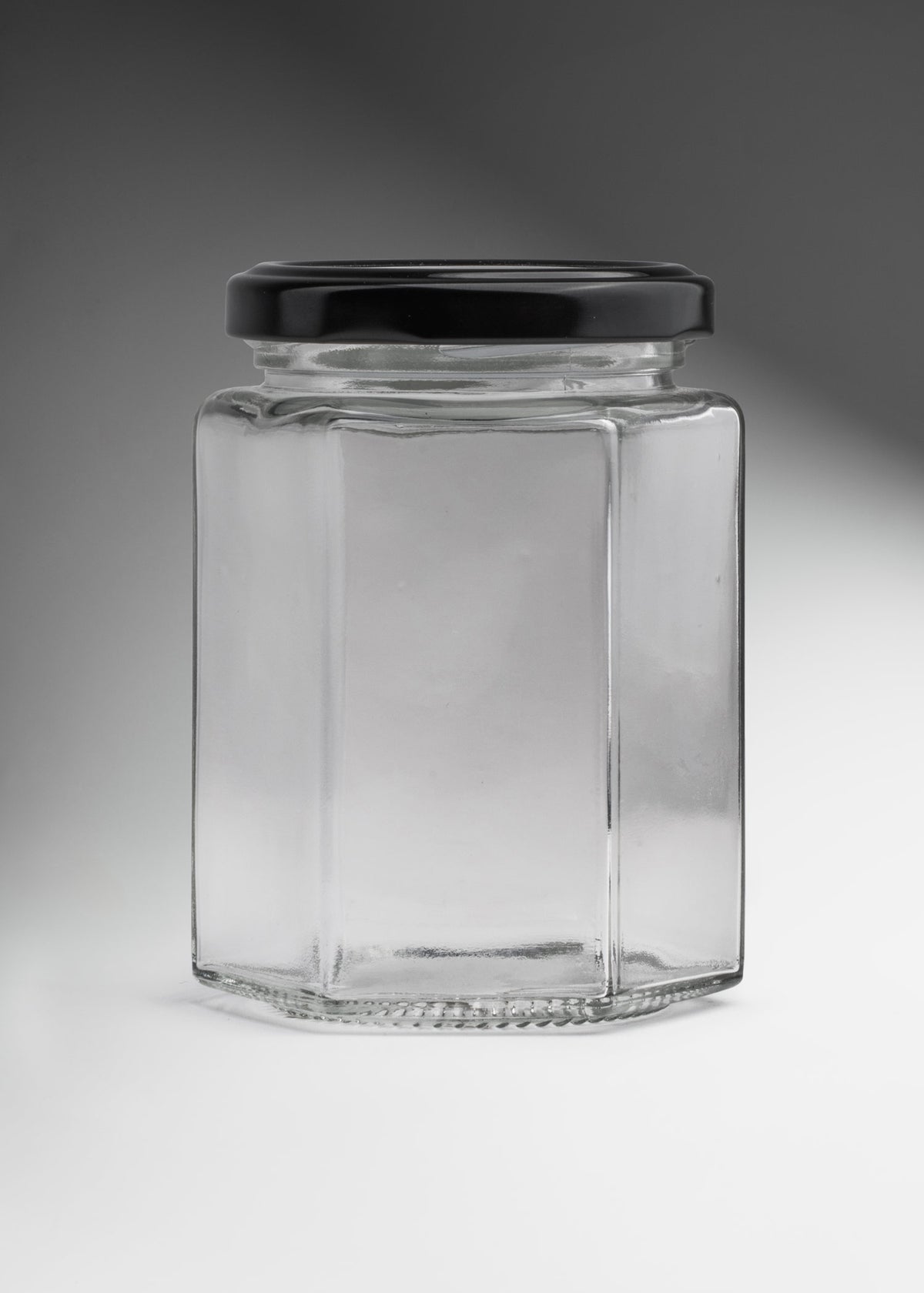 Frascos hexagonales de vidrio transparente con tapa negra uso alimenticio de 45 a 500 ml — imagen de producto