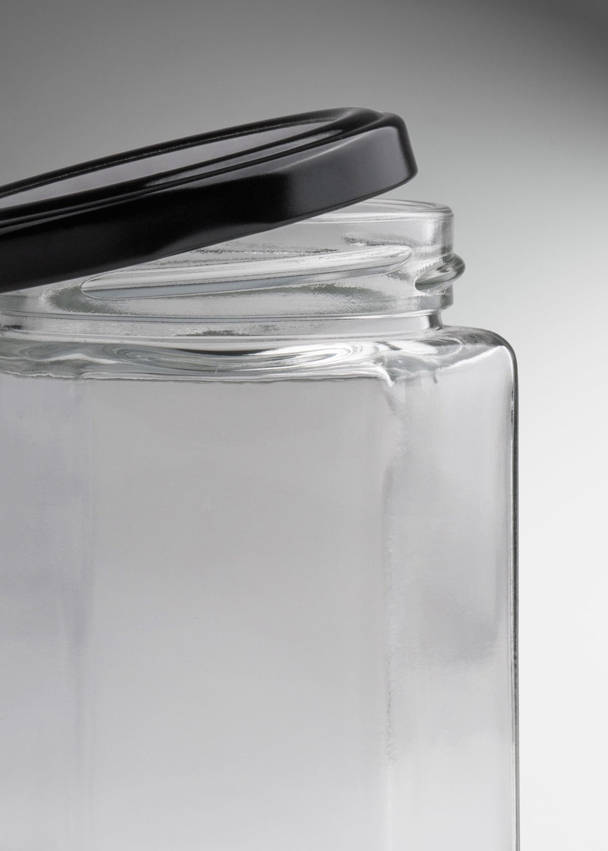Frascos hexagonales de vidrio transparente con tapa negra uso alimenticio de 45 a 500 ml — imagen de producto