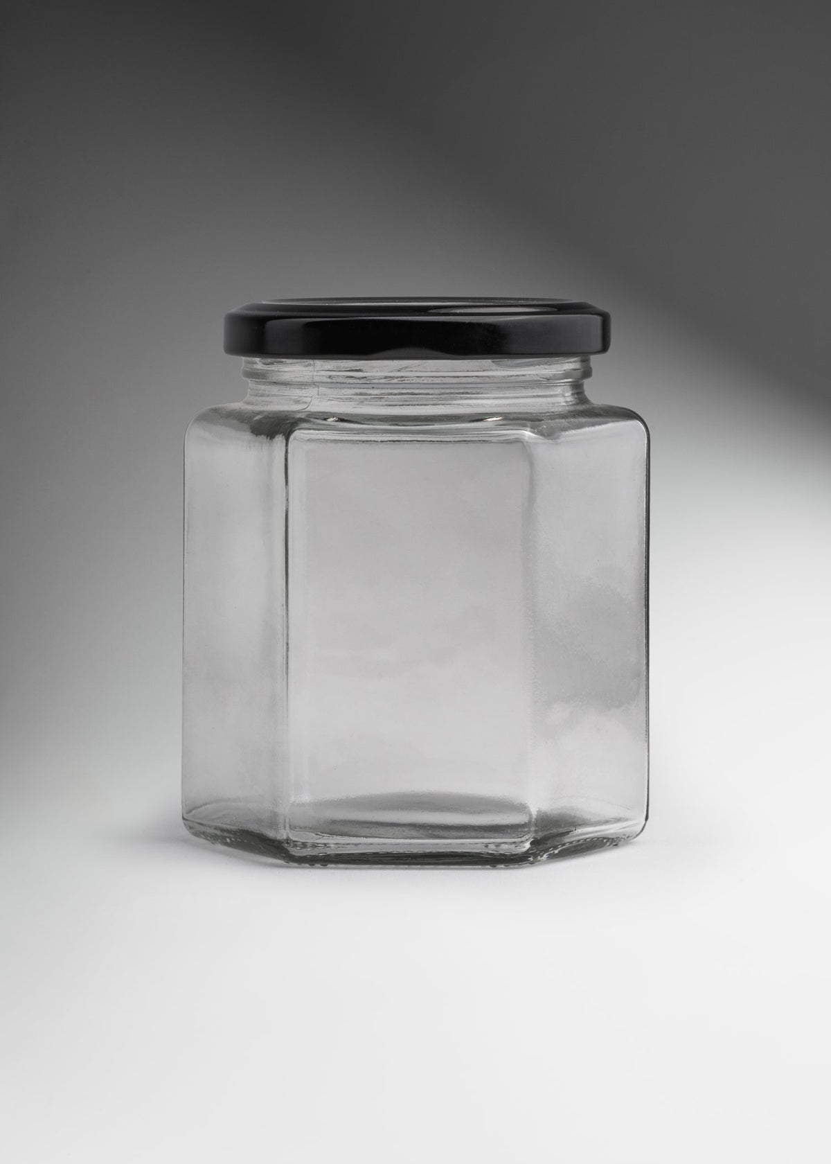 Frascos hexagonales de vidrio transparente con tapa negra uso alimenticio de 45 a 500 ml — imagen de producto