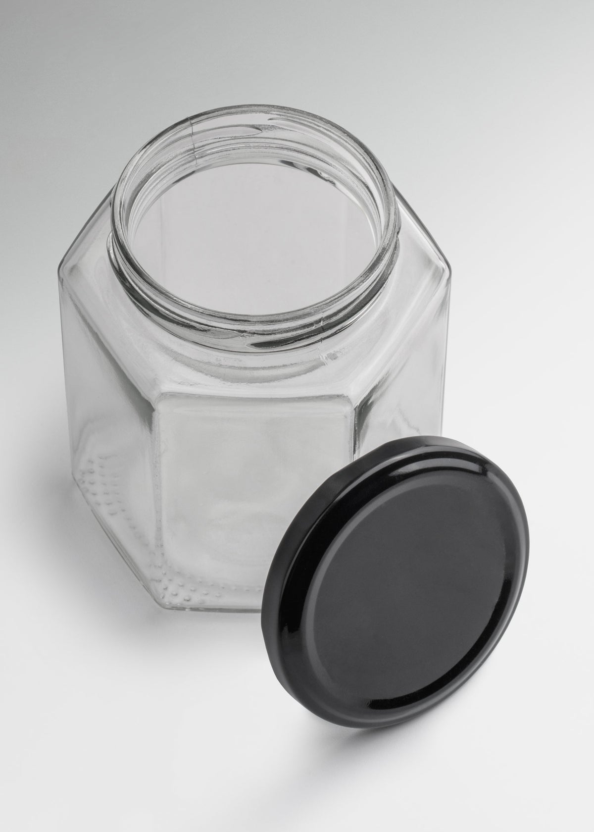 Frascos hexagonales de vidrio transparente con tapa negra uso alimenticio de 45 a 500 ml — imagen de producto