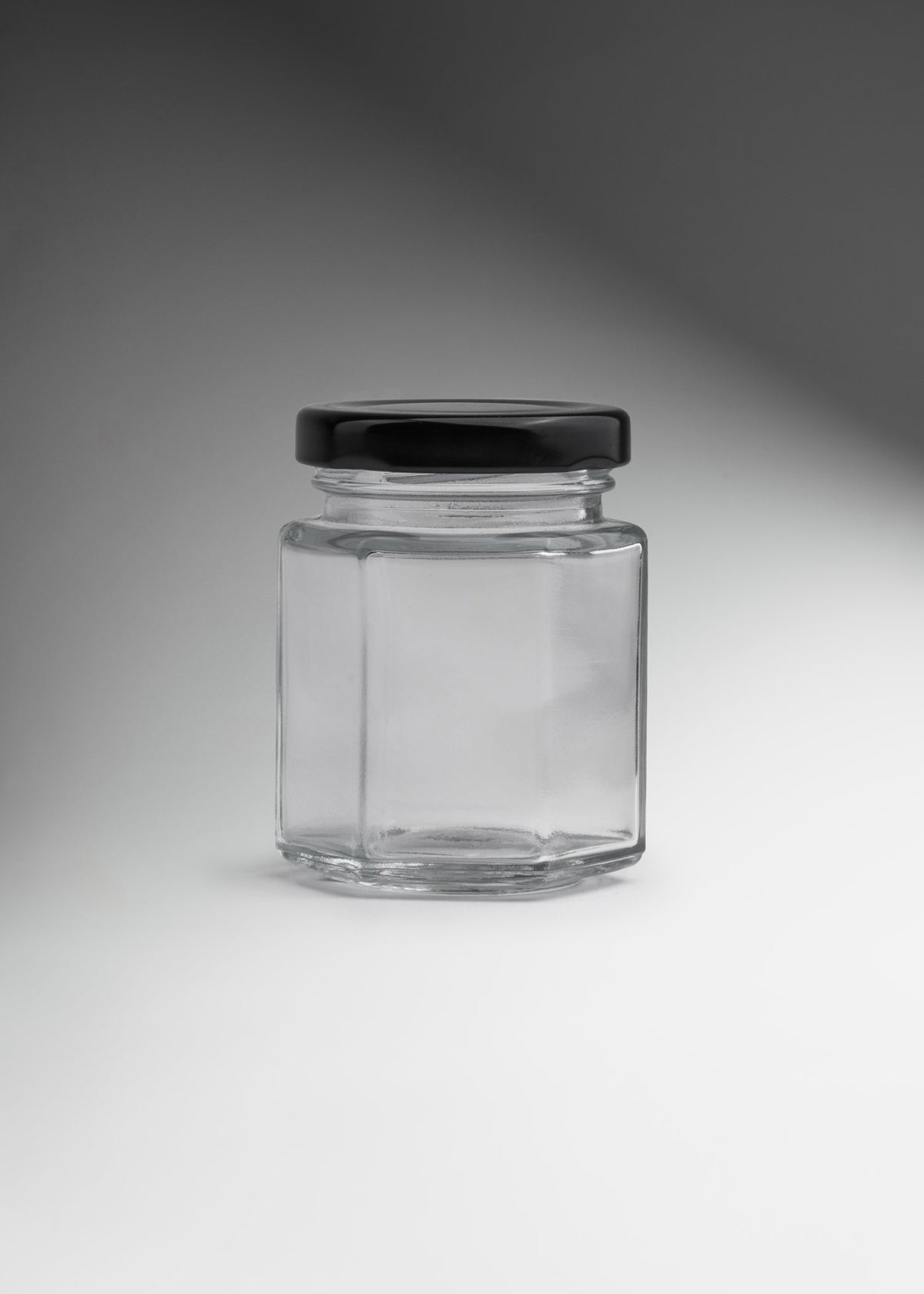 Frascos hexagonales de vidrio transparente con tapa negra uso alimenticio de 45 a 500 ml — imagen de producto