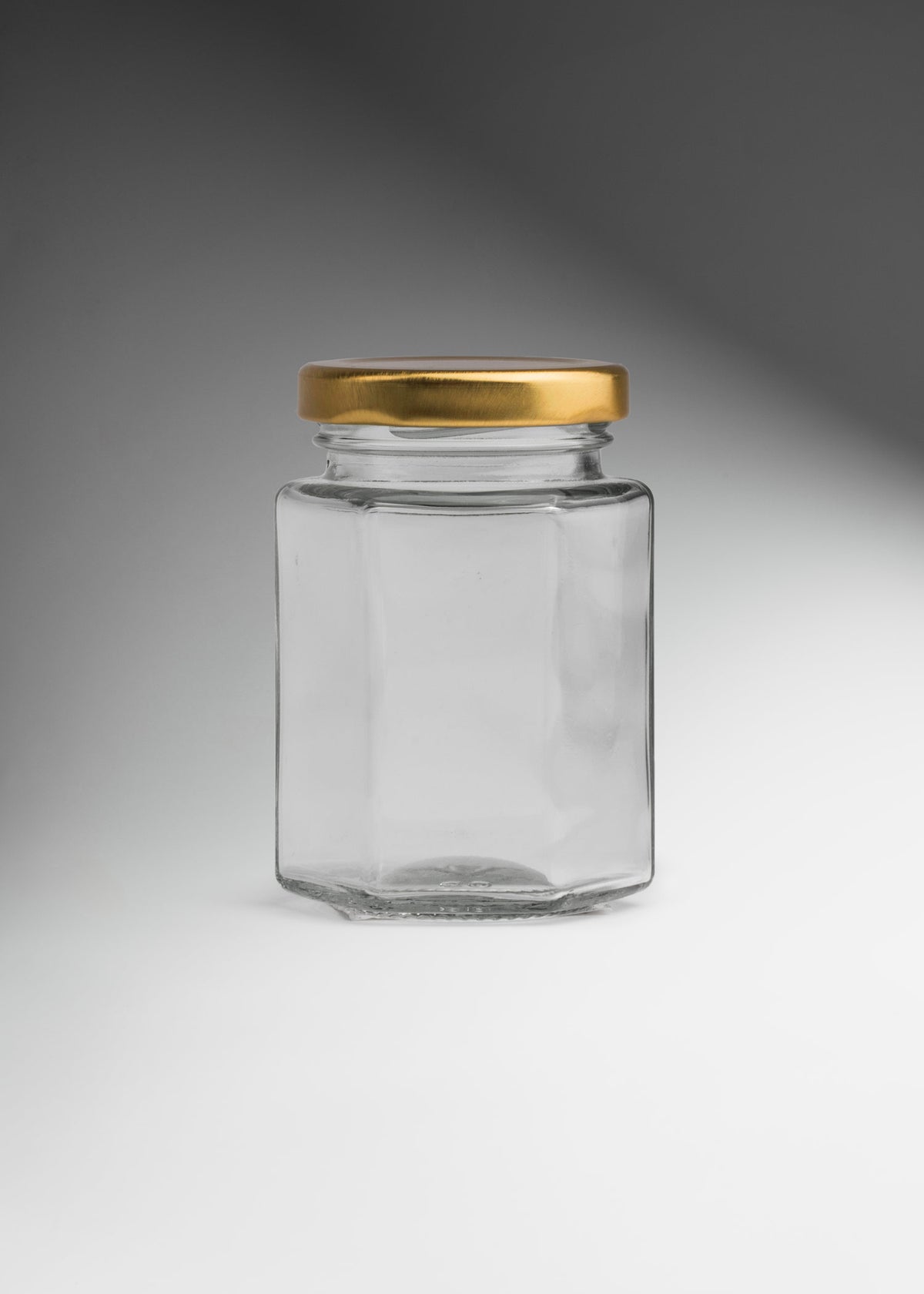 Frascos hexagonales de vidrio transparente con tapa dorada uso alimenticio de 45 a 500 ml — imagen de producto