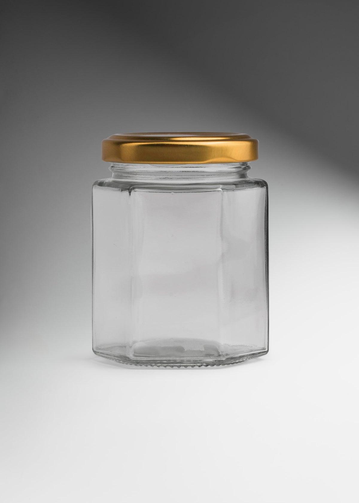 Frascos hexagonales de vidrio transparente con tapa dorada uso alimenticio de 45 a 500 ml — imagen de producto
