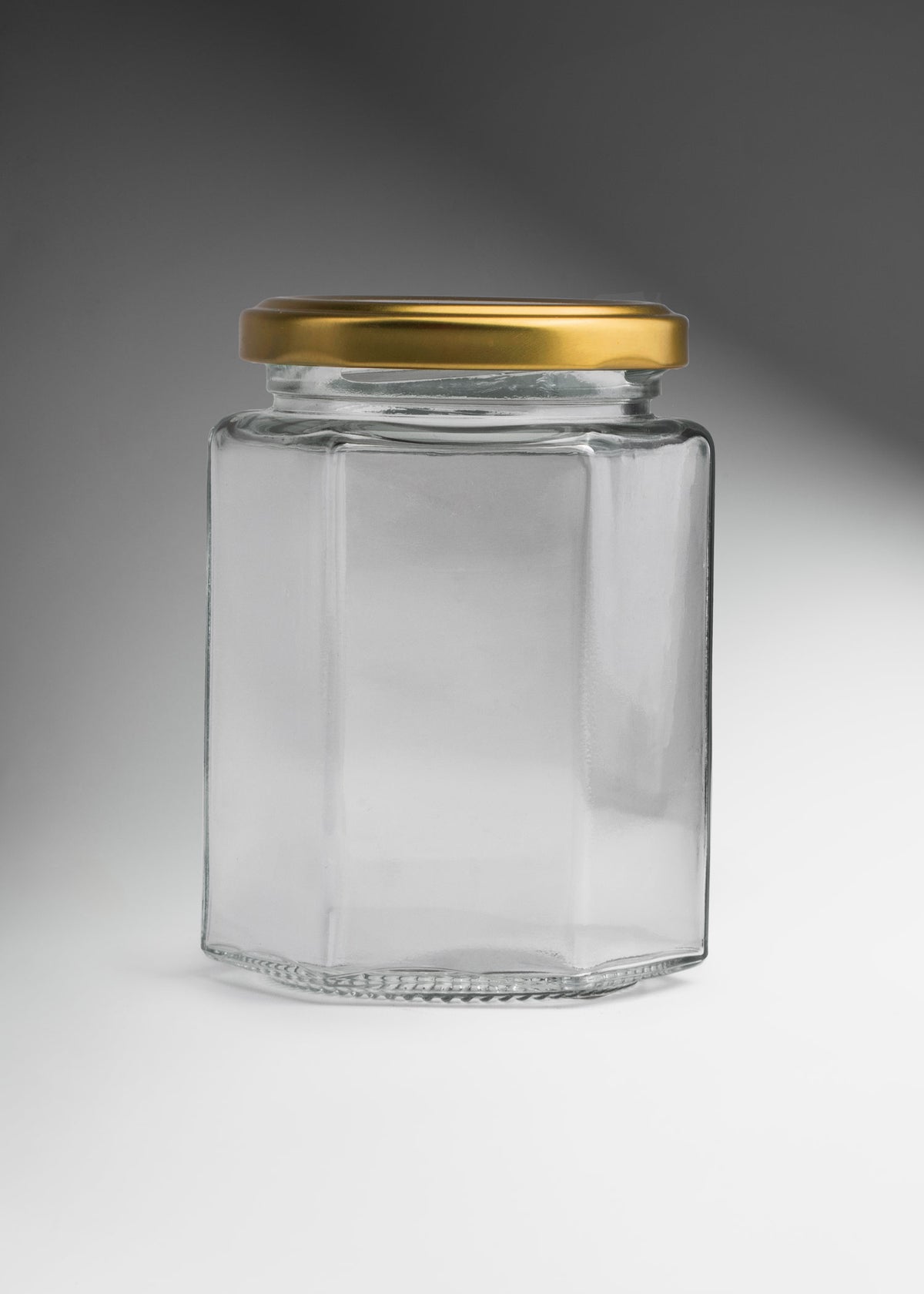 Frascos hexagonales de vidrio transparente con tapa dorada uso alimenticio de 45 a 500 ml — imagen de producto