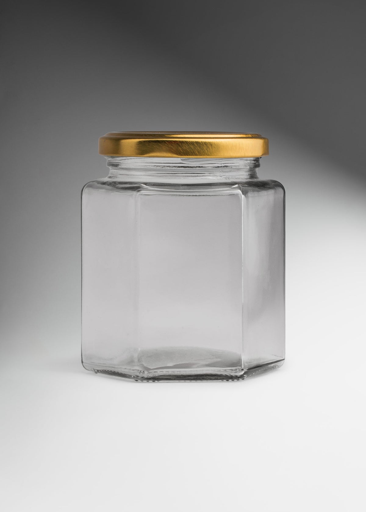 Frascos hexagonales de vidrio transparente con tapa dorada uso alimenticio de 45 a 500 ml — imagen de producto
