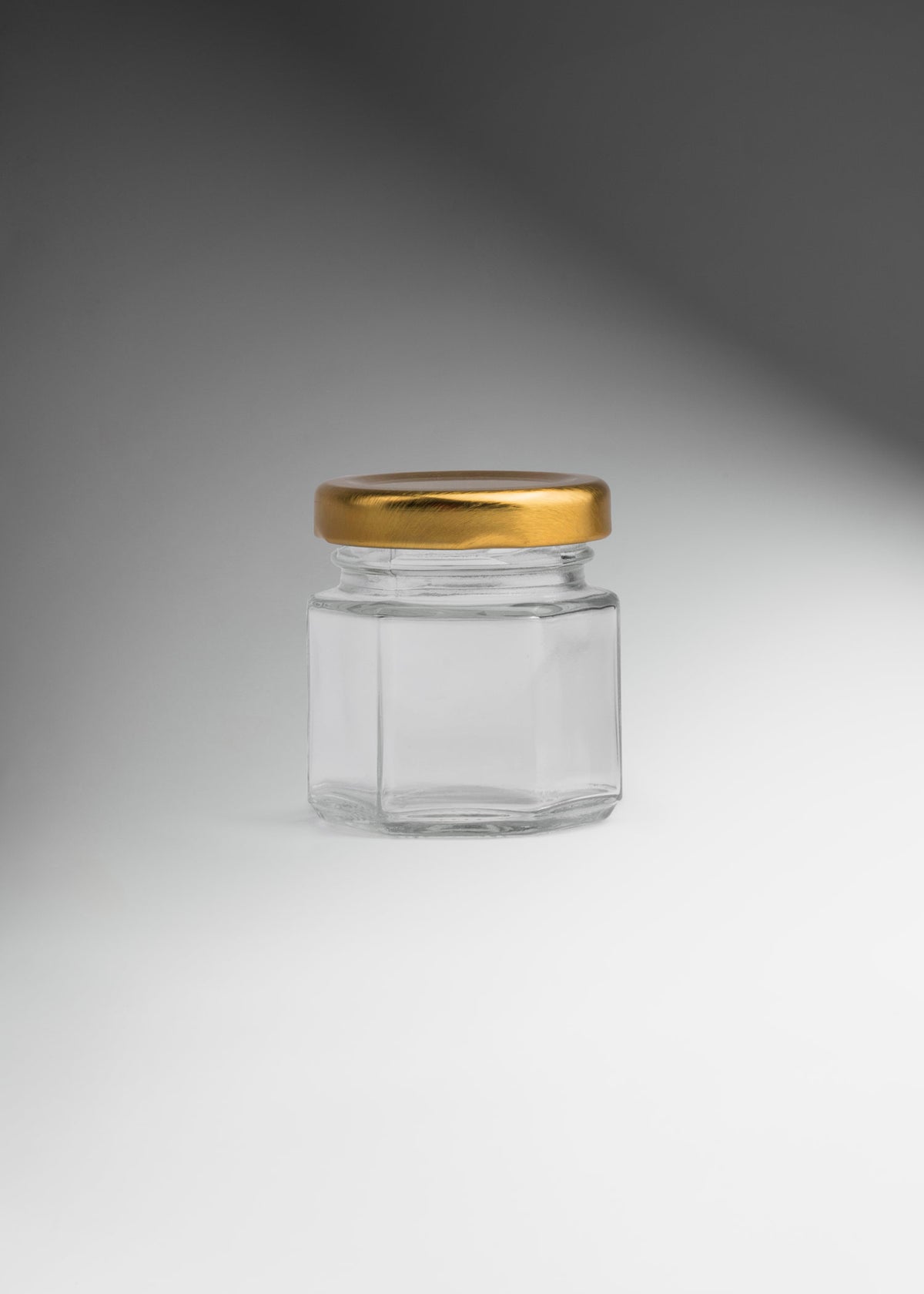 Frascos hexagonales de vidrio transparente con tapa dorada uso alimenticio de 45 a 500 ml — imagen de producto