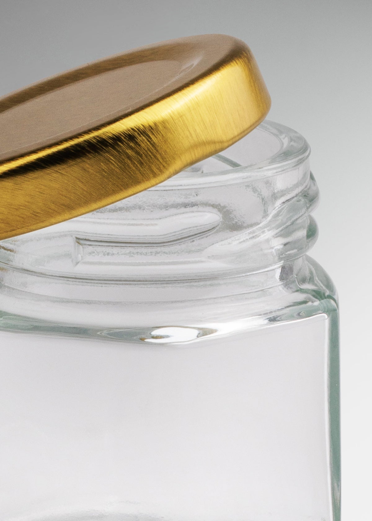Frascos hexagonales de vidrio transparente con tapa dorada uso alimenticio de 45 a 500 ml — imagen de producto