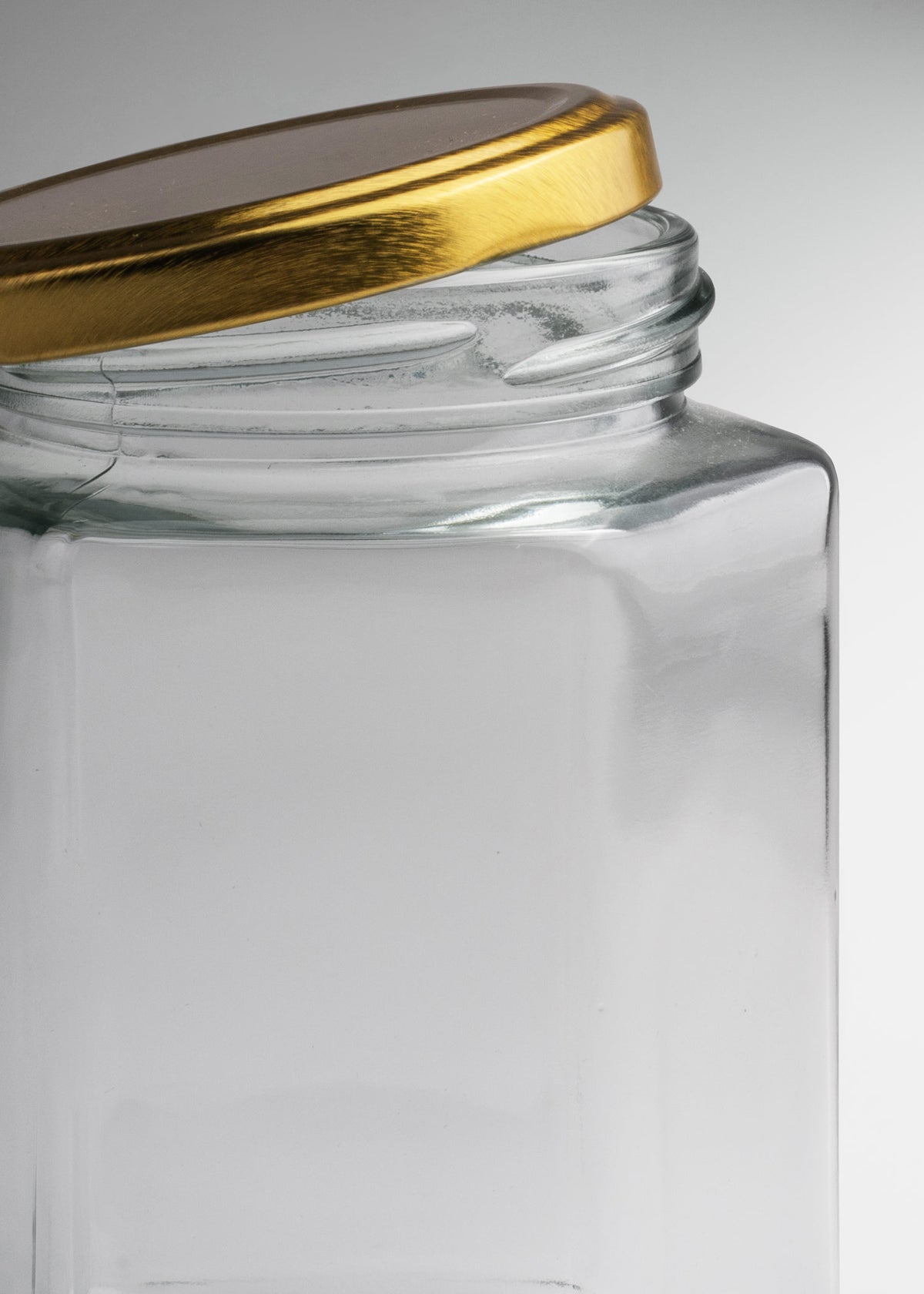 Frascos hexagonales de vidrio transparente con tapa dorada uso alimenticio de 45 a 500 ml — imagen de producto