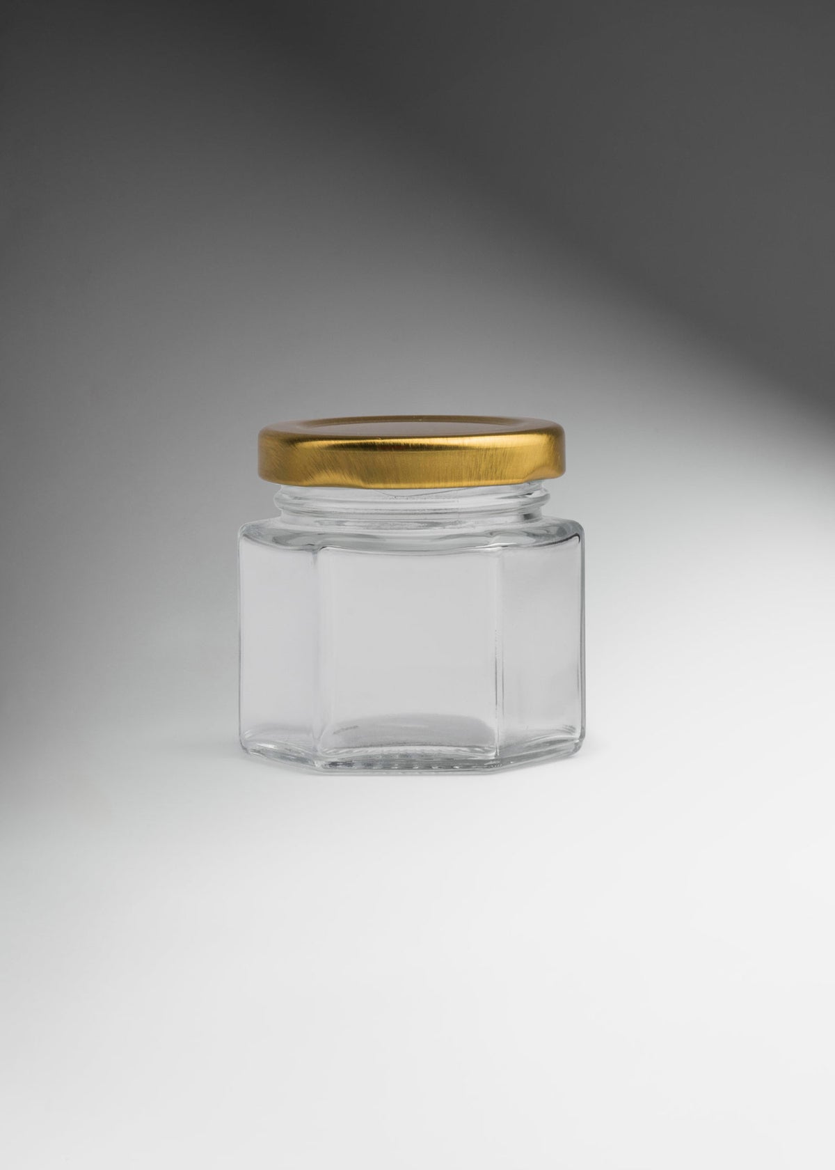 Frascos hexagonales de vidrio transparente con tapa dorada uso alimenticio de 45 a 500 ml — imagen de producto