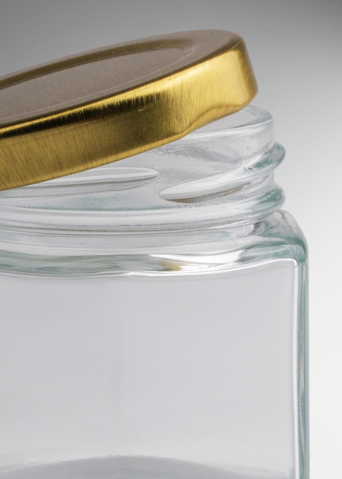 Frascos hexagonales de vidrio transparente con tapa dorada uso alimenticio de 45 a 500 ml — imagen de producto