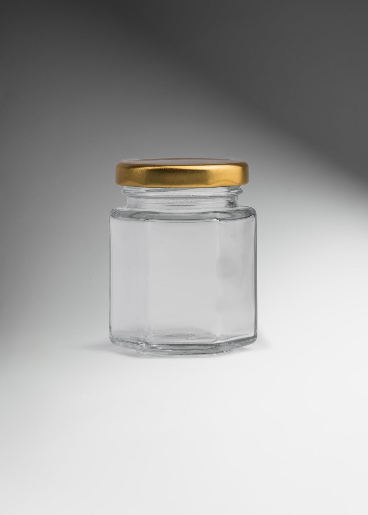 Frascos hexagonales de vidrio transparente con tapa dorada uso alimenticio de 45 a 500 ml — imagen de producto