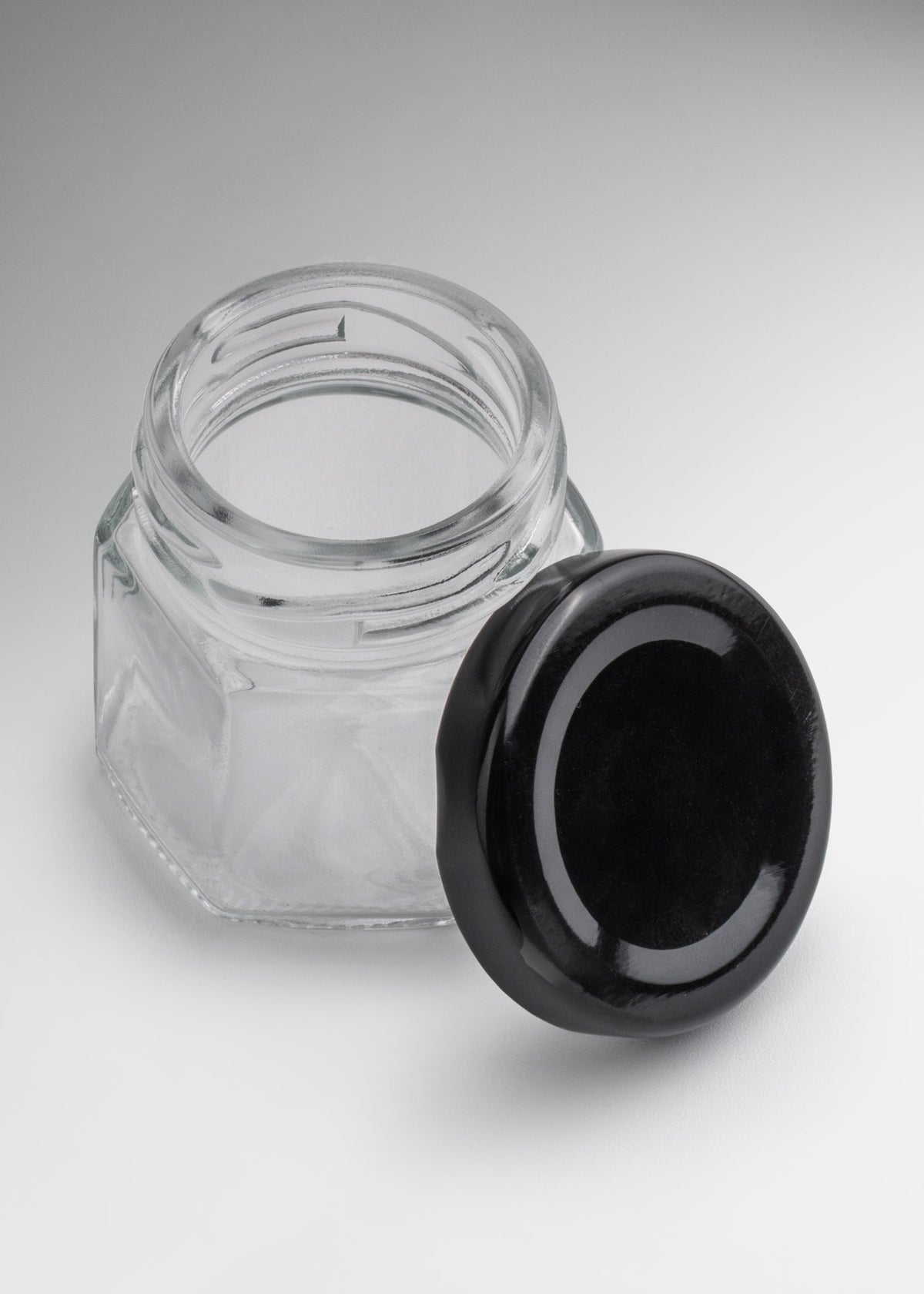 Frascos hexagonales de vidrio transparente con tapa negra uso alimenticio de 45 a 500 ml — imagen de producto