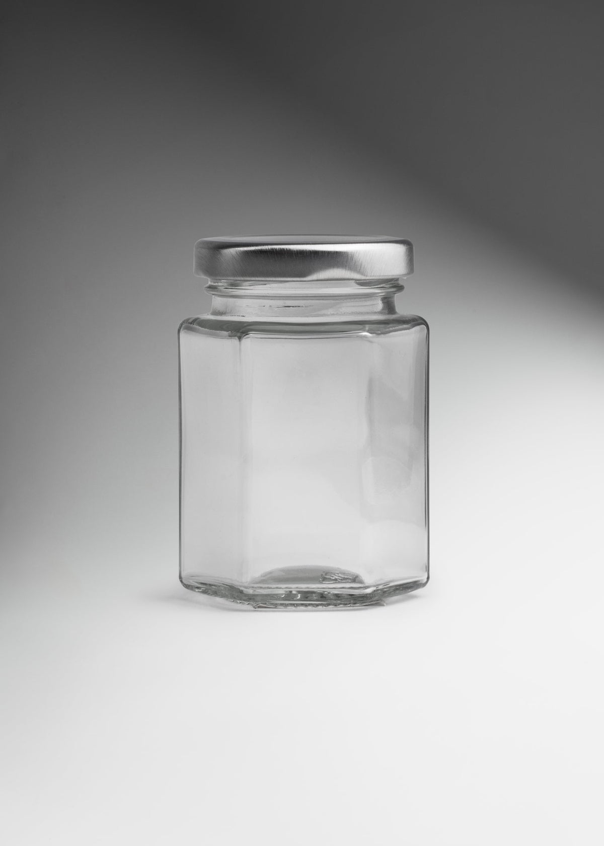 Frascos hexagonales de vidrio transparente con tapa plateada uso alimenticio de 45 a 500 ml — imagen de producto