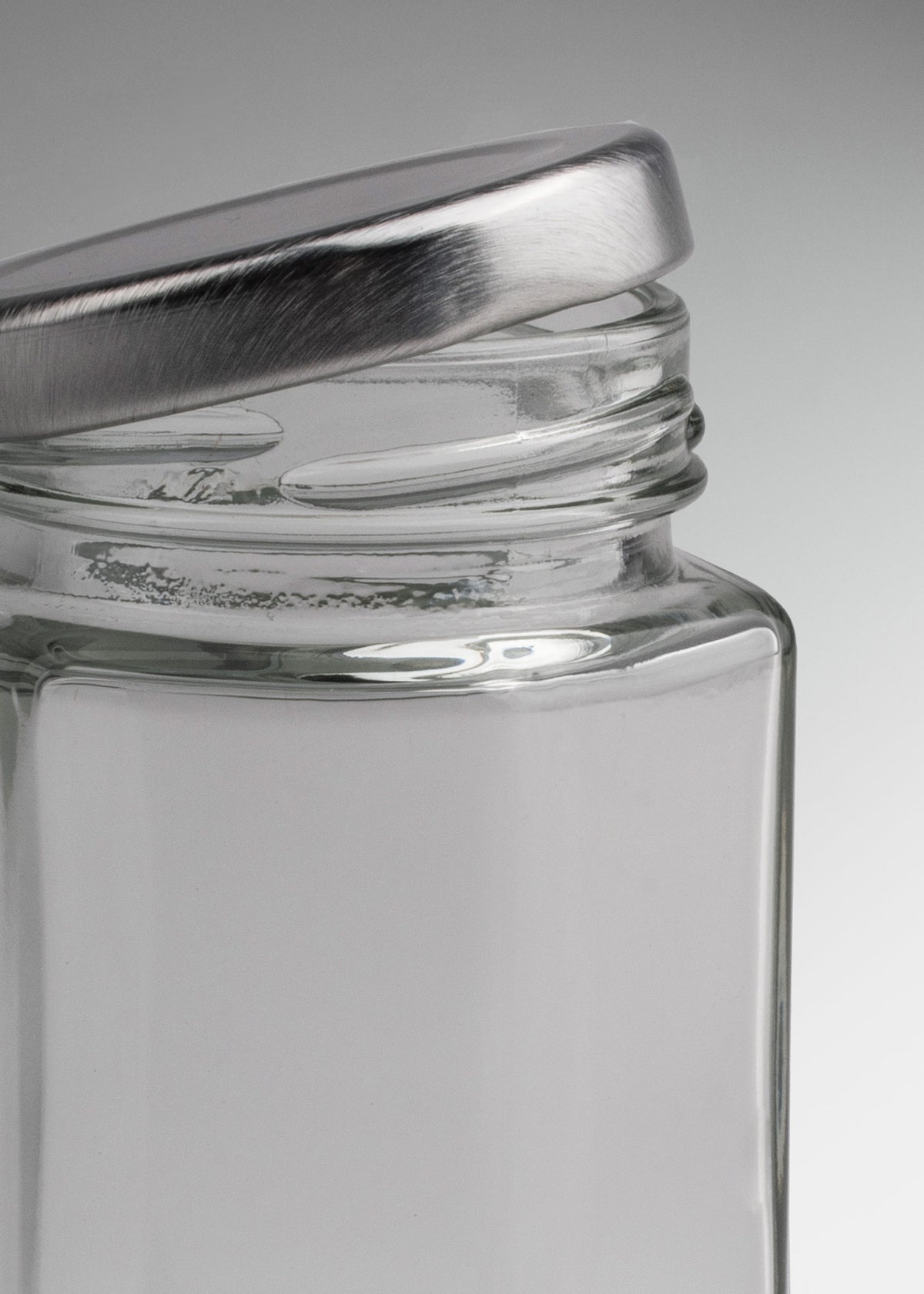 Frascos hexagonales de vidrio transparente con tapa plateada uso alimenticio de 45 a 500 ml — imagen de producto