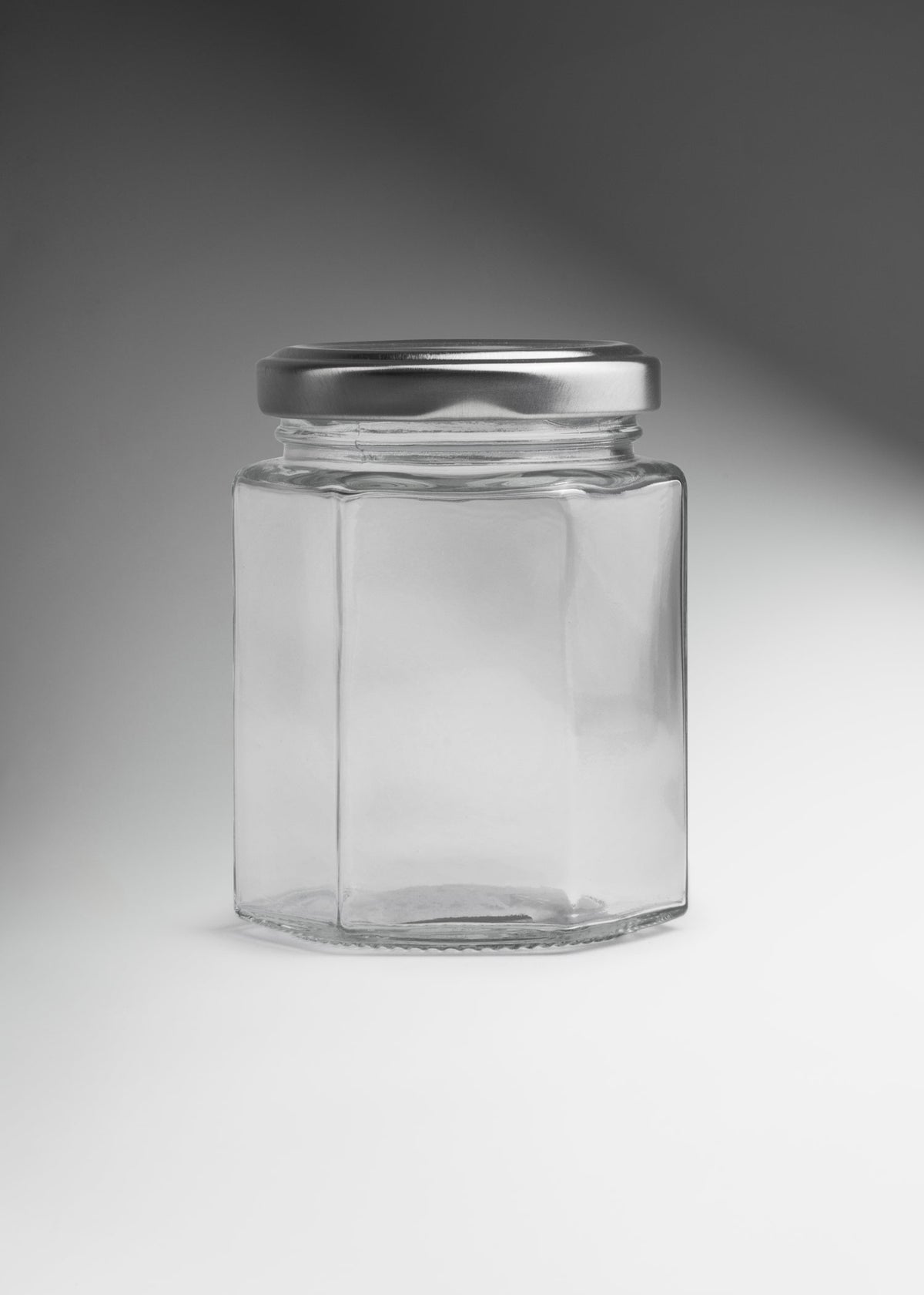 Frascos hexagonales de vidrio transparente con tapa plateada uso alimenticio de 45 a 500 ml — imagen de producto