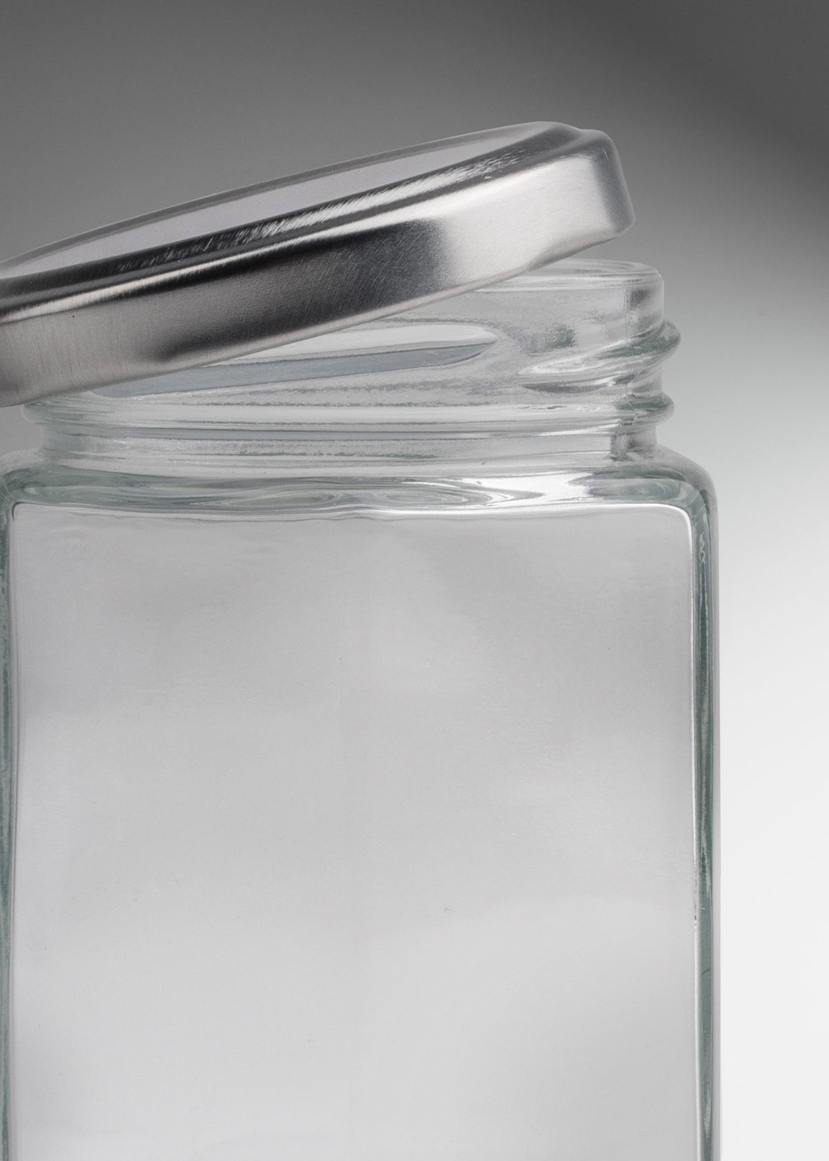 Frascos hexagonales de vidrio transparente con tapa plateada uso alimenticio de 45 a 500 ml — imagen de producto