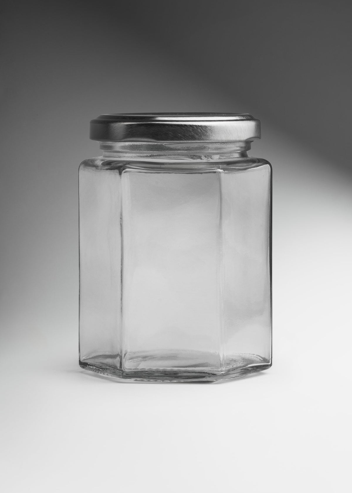 Frascos hexagonales de vidrio transparente con tapa plateada uso alimenticio de 45 a 500 ml — imagen de producto