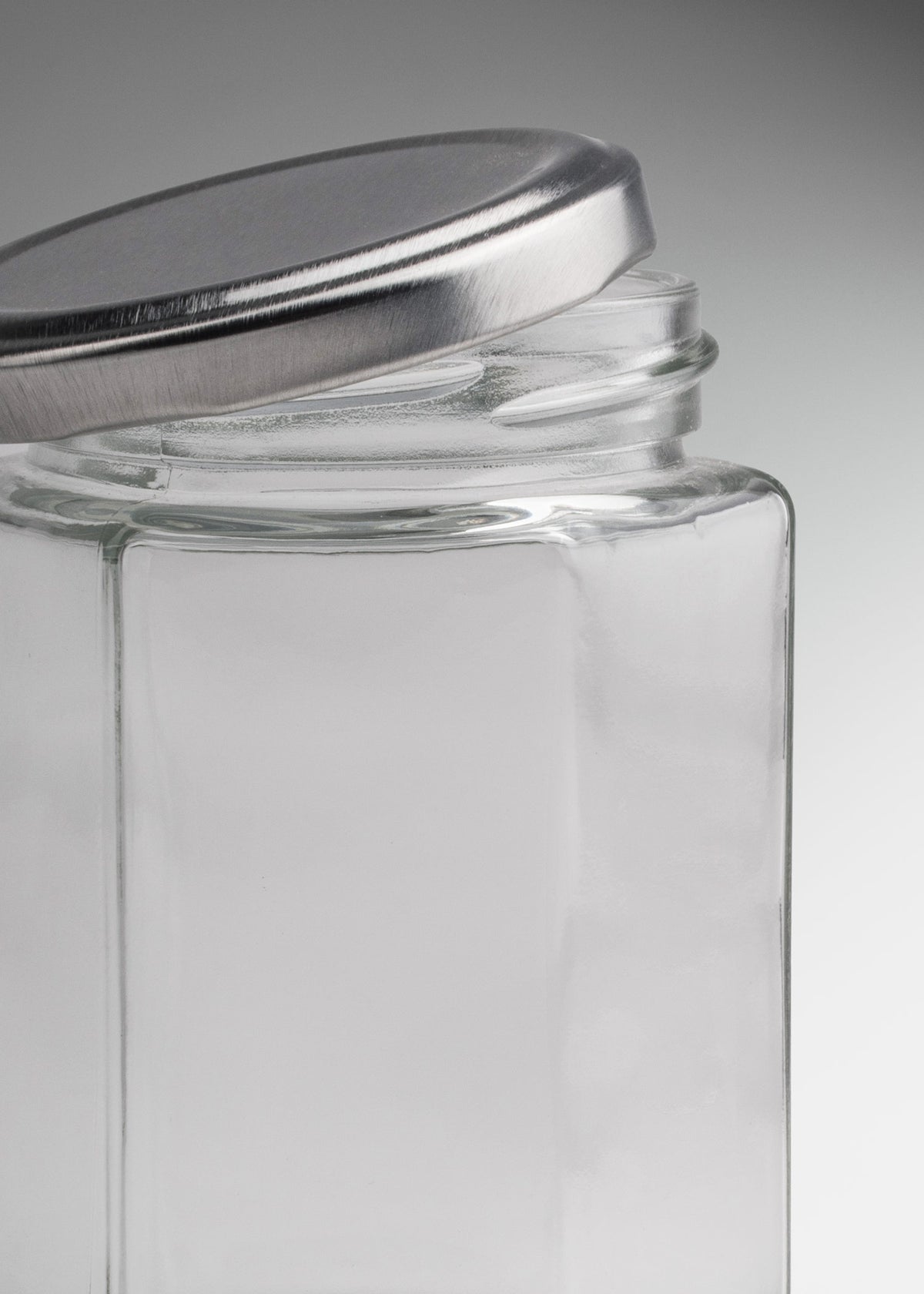 Frascos hexagonales de vidrio transparente con tapa plateada uso alimenticio de 45 a 500 ml — imagen de producto