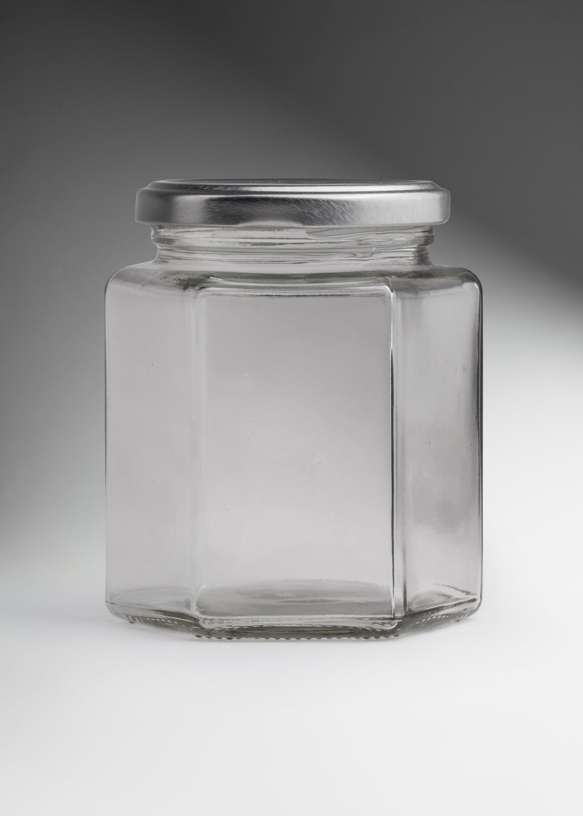 Frascos hexagonales de vidrio transparente con tapa plateada uso alimenticio de 45 a 500 ml — imagen de producto