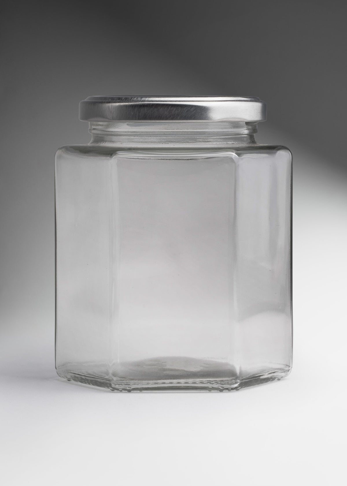 Frascos hexagonales de vidrio transparente con tapa plateada uso alimenticio de 45 a 500 ml — imagen de producto