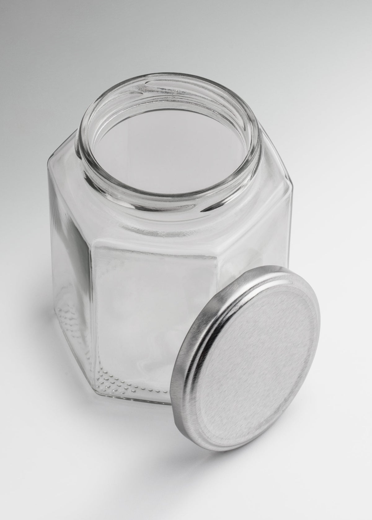 Frascos hexagonales de vidrio transparente con tapa plateada uso alimenticio de 45 a 500 ml — imagen de producto