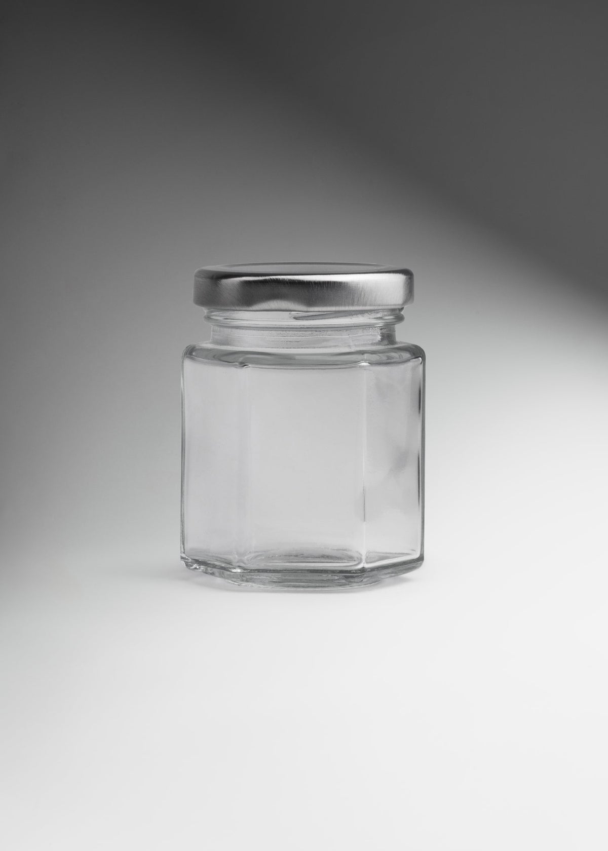 Frascos hexagonales de vidrio transparente con tapa plateada uso alimenticio de 45 a 500 ml — imagen de producto