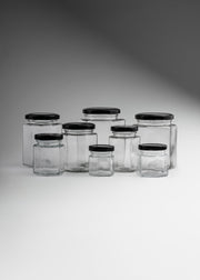 Frascos hexagonales de vidrio transparente con tapa negra uso alimenticio de 45 a 500 ml — imagen de producto
