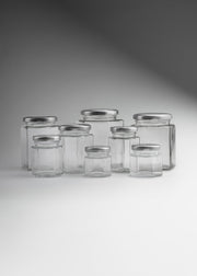 Frascos hexagonales de vidrio transparente con tapa plateada uso alimenticio de 45 a 500 ml — imagen de producto